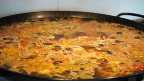 Paella broth simmering gently Stock Footage 147988756