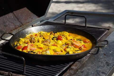 Paella is cooked on a grill Stock Photos