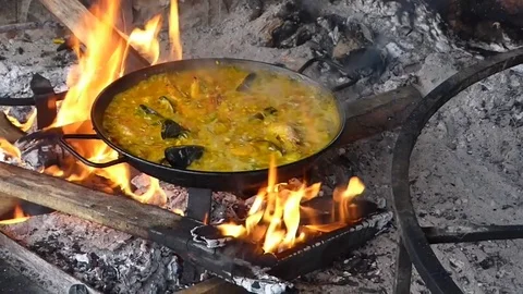 Paella cooking on fire (close) Stock Footage 82471931