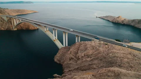 Pag Bridge with driving vehicles lasts over Adriatic sea channel Stock Footage 280502207