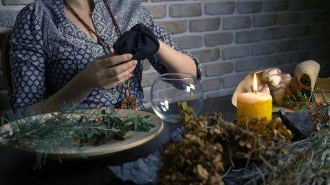 Pagan ritual magic. a potion of herbs. the woman is a witch preparing herbal Stock-Footage 122588102