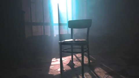 Pages falling on opened book on black chair in dark mystic room filled with haze Stockbeeldmateriaal 198026853