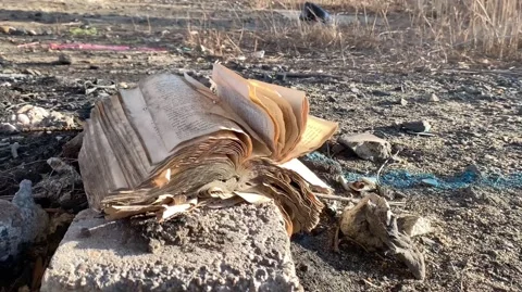 Pages flapping on an open book in the rubble Video stock 144131850