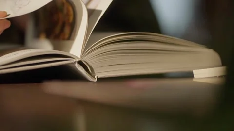 Pages of an open book turning Видео 347845271
