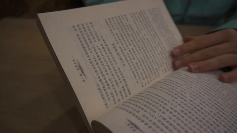 Paging through a Mandarin book Video stock 122491688
