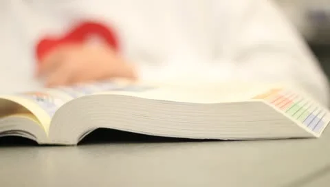 Paging through textbook Stock Footage 10715487