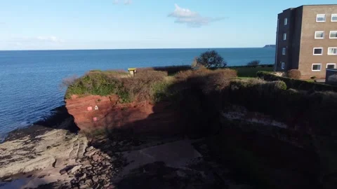 Paignton, Devon, England: Drone View: Fairy Cove, beach, cliffs and apartments Stock Footage 171375592