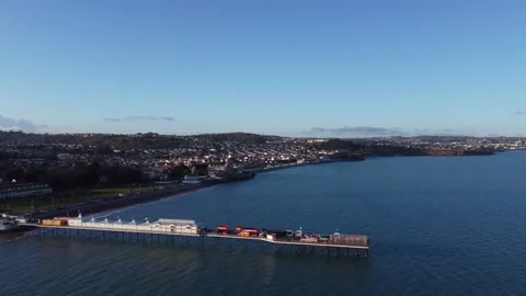 Paignton, Devon, England: Drone View: Paignton pier, green &amp; promenade Stock Footage 198501751