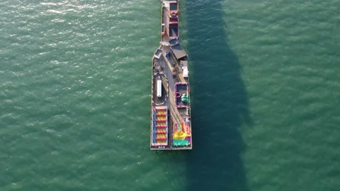 Paignton, Devon, England: OVERHEAD DRONE VIEW: Full length of Paignton pier Stock Footage 172222965