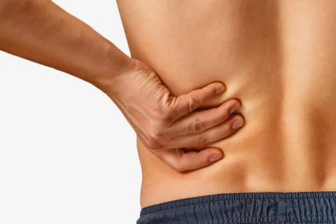 Pain in the lower back, close-up Stock Photos