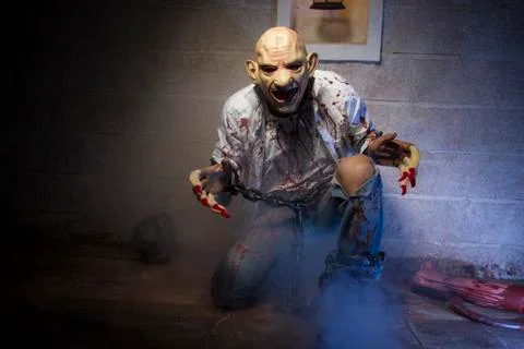 Pain, Man chained with blood and knife, has a severed leg blood Stock Photos