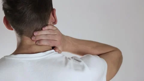 Pain in the neck of a man. On a gray background. Stock Footage 141490782