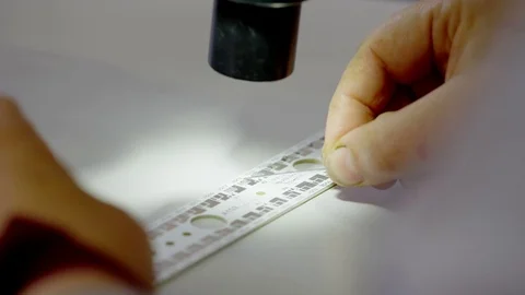 Painstaking work under a microscope Stock Footage 78336305