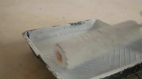 The paint is applied to the paint roller Stock-Footage 153256513