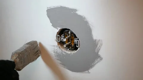 Paint around the outlet. Close-up Stock Footage 153472211