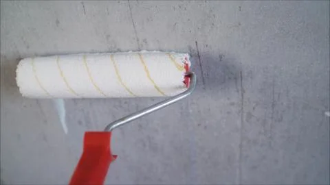 Paint the bare wall with a paint roller. Hand painted by roller. Primer Wall  Stock Photos