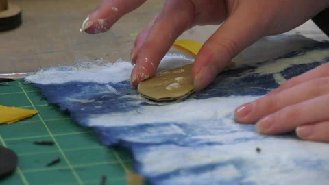 Paint being applied to material using a stamp Stock Footage 239654023