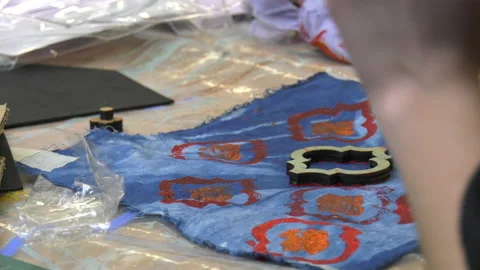 Paint being applied to material using a stamp Stock Footage 239655054