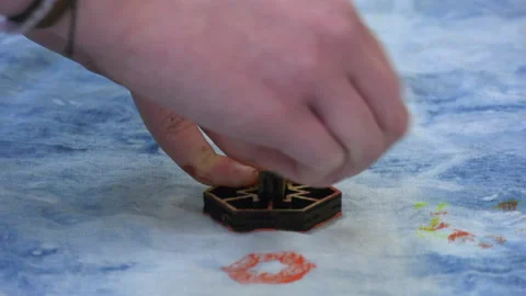 Paint being applied to material using a stamp Stock Footage 239655117