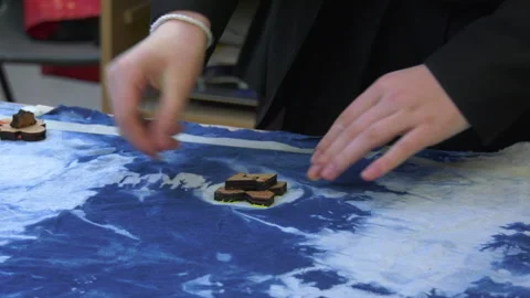 Paint being applied to material using a stamp Stock Footage 239655130