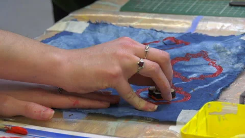 Paint being applied to material using a stamp Stock Footage 239655131