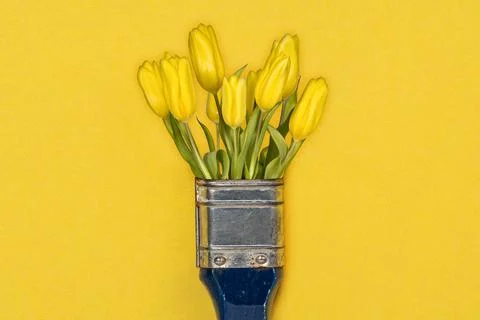 Paint brush and yellow tulip flowers Stock Photos