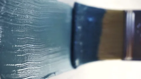 Paint brush in blue wall Stock Footage 62022967