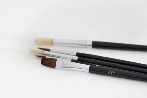 Paint brush, creativity and table background with hobby and diy tool. Creative Stock Photos