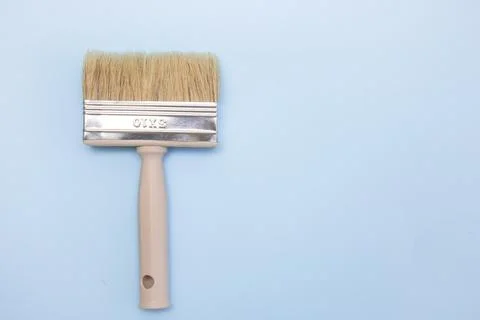 Paint brush on a light blue background with copy space Stock Photos