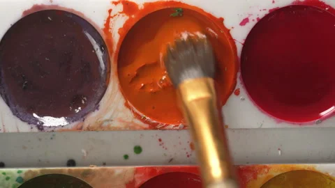 Paint Brush Picking Orange Color From Palette Stock Footage 339047744