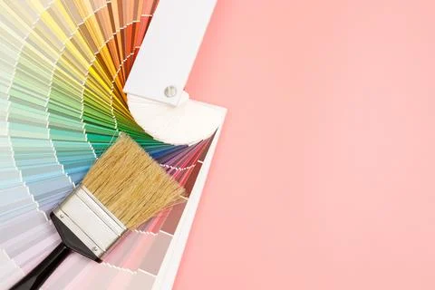 Paint brush on pink background, how to choose the perfect home paint color .. Stock Photos