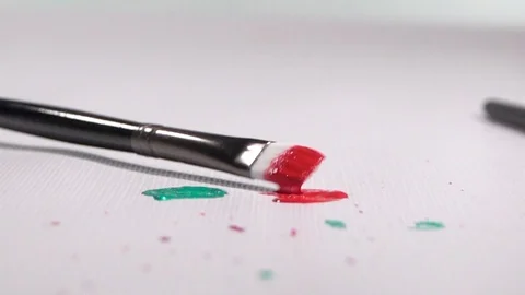 Paint Brush with Red Paint Bouncing onto White Background in Slow Motion 스톡 동영상 129930669