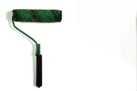 Paint brush roller on white background with copy space. Green used paint tool 스톡 사진