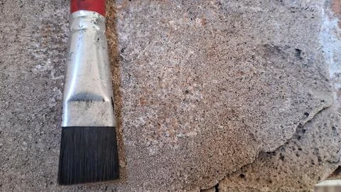 Paint brush on a rough stone surface. Artist tool for painting on textured Stock Photos