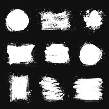 Paint brush stains. Vector grunge shapes isolated on black backgrounds. Illustrazione stock