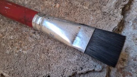 Paint brush on textured stone surface. Artist tool for painting and creative art Stock Photos