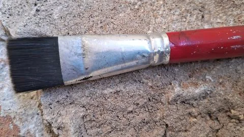 Paint brush on a textured stone surface. Artist tool for painting and creative Stock Photos