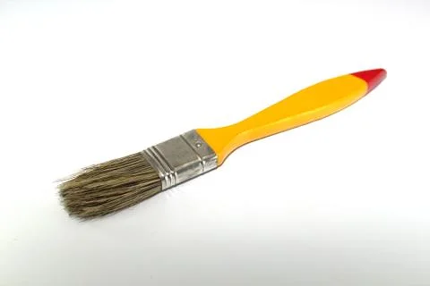 Paint brush width 1 inch with a yellow handle on a white background Stock Photos