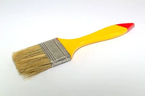 Paint brush width 2 inches with a yellow handle on a white background Stock Photos