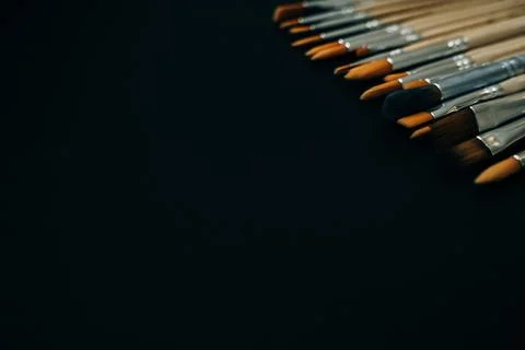 Paint brushes on black background Stock Photos
