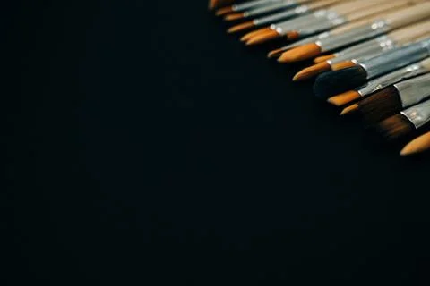 Paint brushes on black background Stock Photos