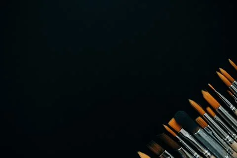 Paint brushes on black background Stock Photos