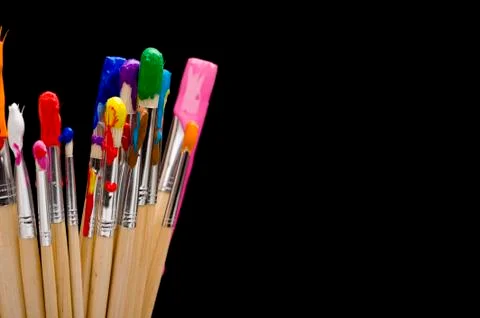 Paint brushes on black Stock Photos