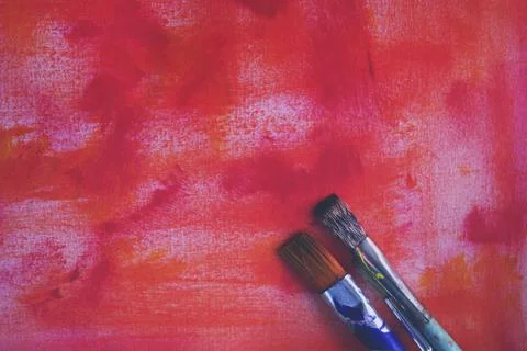 Paint brushes on canvas background Stock Photos