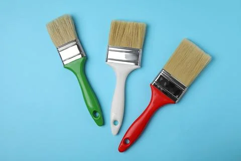 Paint brushes on color background, top view Stock Photos