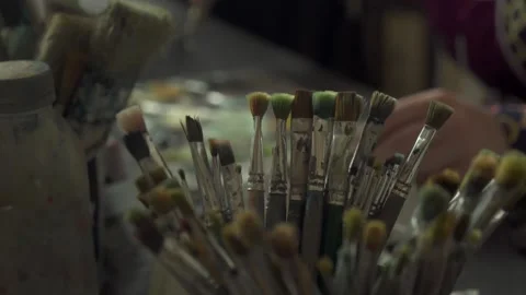 Paint brushes in different sizes. The artist paints a picture Video stock 160984837