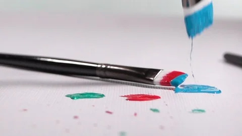 Paint Brushes falling and bouncing onto a White Background in Slow Motion Stock Footage 129930594