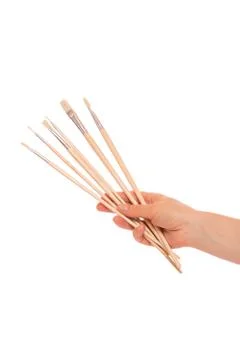 Paint brushes in hand Stock Photos