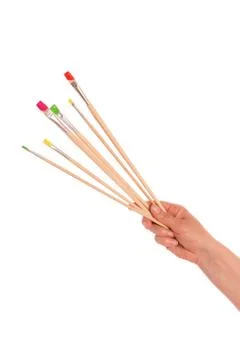 Paint brushes in hand Stock Photos