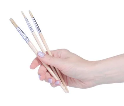 Paint brushes in hand Stock Photos